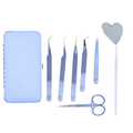 Set of Periwinkle blue tweezers, scissors, and a heart-shaped mirror tool on a white background